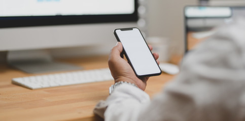Close-up view of businessman looking for new information on smartphone