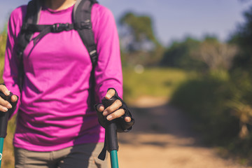 Close up of hands backpacking Asian woman holding trekking pole,Camping hiking concept