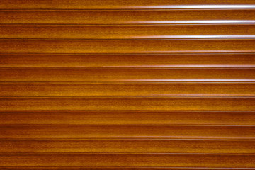 orange faux wood background texture the fence, siding. Plastic fence orange faux wood striped