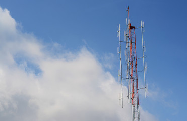 Communications Tower with a Blue Sky Background. Radio tower with antennas on a blue sky background.