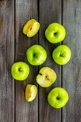 Autumn composition with green apple on dark wooden background top view