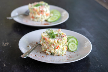 Healthy homemade russian traditional salad olivier ready to eat, close up