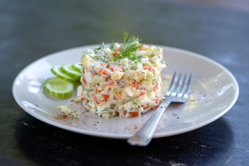 Healthy homemade russian traditional salad olivier ready to eat, close up