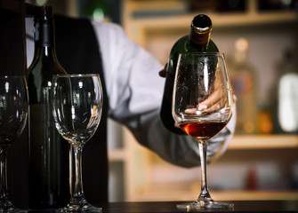 Bartender Serve wine, on wood bar, 