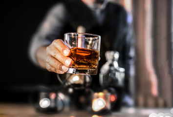 Closeup businessmen holding a glass of whiskey