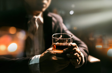 Closeup businessmen holding a glass of whiskey