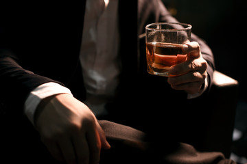 Closeup businessmen holding a glass of whiskey
