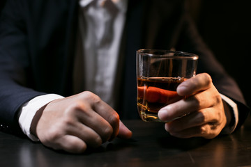 Closeup businessmen holding a glass of whiskey