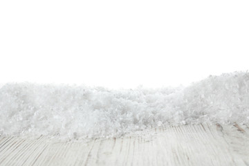 Heap of snow on wooden surface against white background. Christmas season