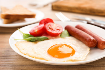 Fototapeta na wymiar Tasty breakfast with fried egg on wooden table, closeup