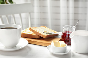 Tasty breakfast with toasts served on white wooden table