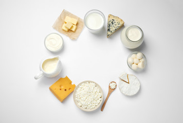 Frame made with different dairy products on white background, top view. Space for text