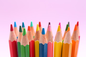 Different color pencils on lilac background, closeup