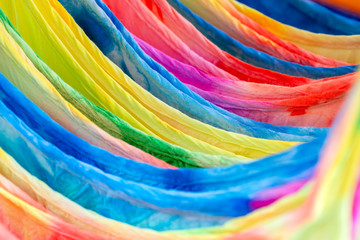 Summer clothes on hangers for sale in local street market in Thailand, close up