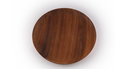 Round wooden plate on white background, view from above.