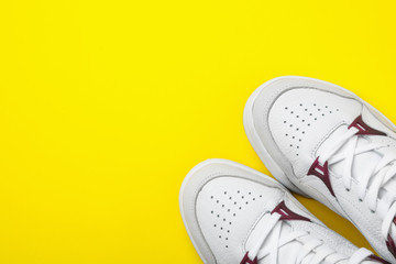 Pair of stylish shoes on yellow background, top view. Space for text