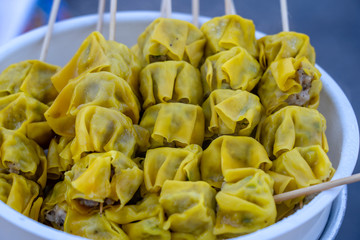 Steamed dimsum in bamboo at street food market in Thailand. Dim sum a Chinese dish of small steamed or fried savory dumplings containing various fillings, served as a snack or main course