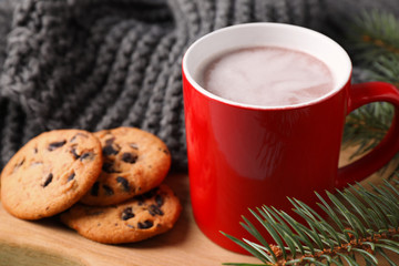 Cup of tasty cocoa and cookies on wooden board