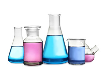 Laboratory glassware with colorful liquids on white background