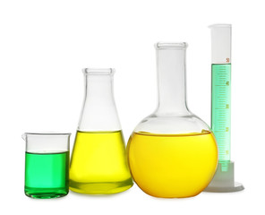 Laboratory glassware with colorful liquids on white background