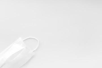 Flu prevention concept. Medical face mask on white background top view copy space