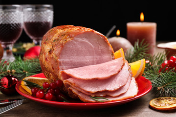 Plate with delicious ham served on wooden table. Christmas dinner
