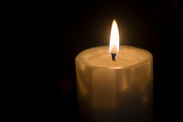  burning candle in the dark