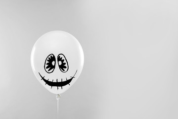 Spooky balloon for Halloween party on light grey background, space for text