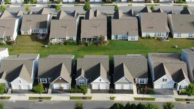 Slow Aerial Tilt Up Revealing Identical Homes In Suburban America, USA, Identical Homes In Summer Sunlight