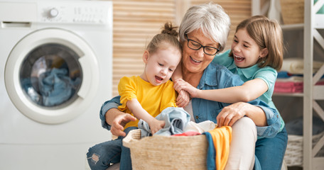 grandma and children are doing laundry