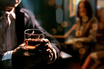 Closeup businessmen holding a glass of whiskey