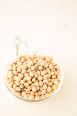 Soybeans are in a cup, placed on a wooden table with copy space,Dry bean yellow  color