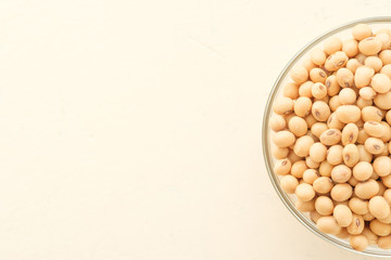 Soybeans are in a cup, placed on a wooden table with copy space,Dry bean yellow  color