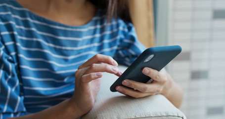 Close up of woman use of cellphone at home