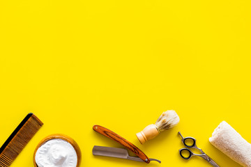 Men's shaving accessories on yellow background top view copy space