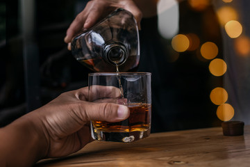 Bartender Serve Whiskey, on wood bar 