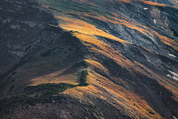 Fototapeta na wymiar Afternoon sunlight illuminating a rocky mountain ridge line in Rocky Mountain National Park