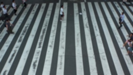 UMEDA, OSAKA, JAPAN - CIRCA SEPTEMBER 2019 : Aerial blurred view of zebra crossing near Osaka train station. Crowd of people at the street. Shot in busy rush hour. Slow motion.