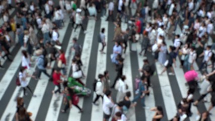 UMEDA, OSAKA, JAPAN - CIRCA SEPTEMBER 2019 : Aerial blurred view of zebra crossing near Osaka train station. Crowd of people at the street. Shot in busy rush hour. Slow motion.