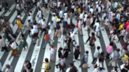 UMEDA, OSAKA, JAPAN - CIRCA SEPTEMBER 2019 : Aerial blurred view of zebra crossing near Osaka train station. Crowd of people at the street. Shot in busy rush hour. Slow motion.