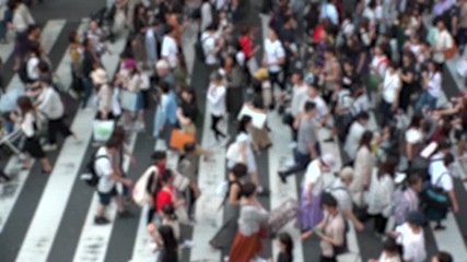 UMEDA, OSAKA, JAPAN - CIRCA SEPTEMBER 2019 : Aerial blurred view of zebra crossing near Osaka train station. Crowd of people at the street. Shot in busy rush hour. Slow motion.