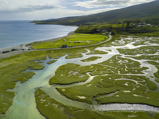 High altitude view of green river delta and ocean coastline in Ireland