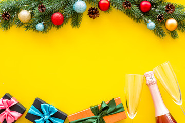 New Year frame with champagne and wineglasses on yellow background top view copy space
