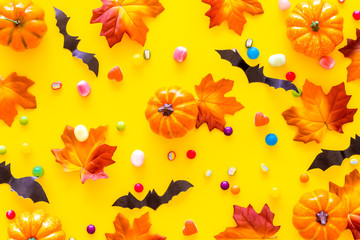 Obraz na płótnie Canvas Nice halloween background with sweets. Cookies and pumpkins on yellow top view