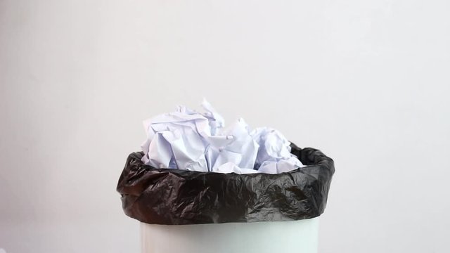 Hand of woman binding black garbage bags in trash to be classified. Concept save the earth.