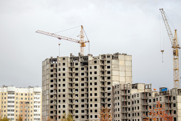 Fototapeta premium The construction of a tall frame building.