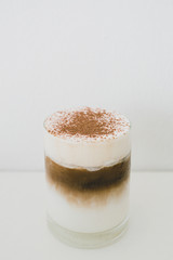 Coffee layers in a glass on white background