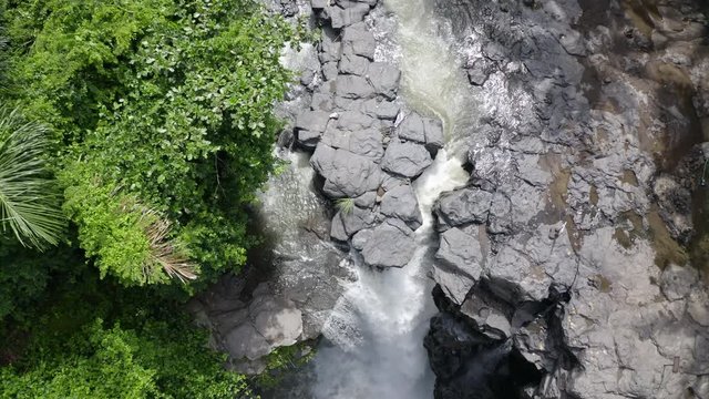 Aerial: Beautiful Tegenungan Waterfall on sunny day - Bali, Indonesia