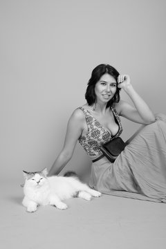 Young beautiful woman with Persian cat shot in black and white