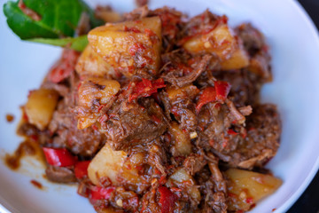 Indonesian dish - fried meat in chili sauce, closeup